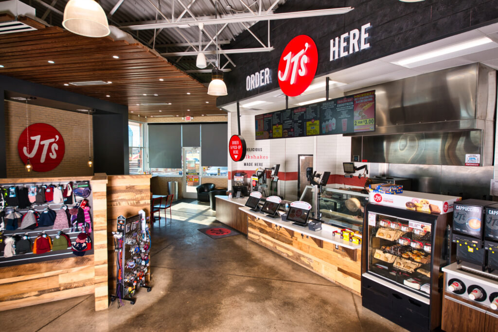 Modern Jiffy Trip store interior with food service area and retail merchandise displays.