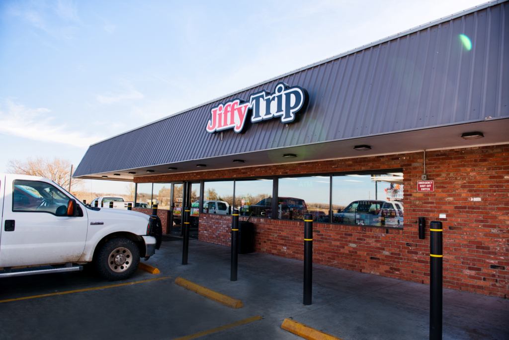 Side view of a Jiffy Trip store with safety bollards.